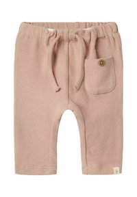 Pantaloni jogger in maglia beige con cintura elastica, cordoncino e una tasca piccola con un dettaglio in legno a forma di bottone.