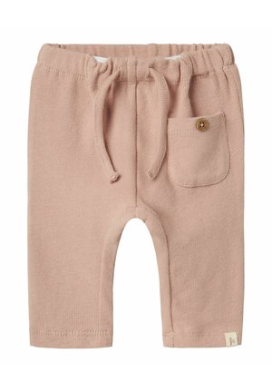 Pantalons de jogging en tricot beige avec une taille élastique, cordon de serrage et une petite poche avec un détail en bouton en bois.