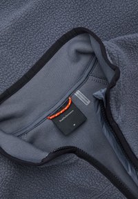 Fleece zip-up jacket in dark gray. Features a textured outer layer, smooth inner lining, black accents, and a red drawstring at the collar.