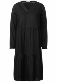 Das schwarze Kleid hat einen V-Ausschnitt, lange Ärmel mit elastischen Bündchen, ein gestuftes Design und eine lockere Passform. Es besteht aus weichem, leichtem Stoff.