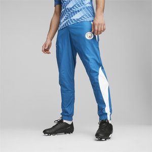 Pantalones deportivos azules hechos de material ligero, con paneles laterales blancos y puños elásticos. Parche de logo situado en el muslo.