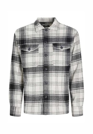 Chemise à carreaux noir et blanc en tissu doux, dotée d'un devant à boutons, de deux poches poitrine et d'un col classique.