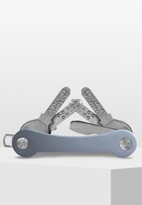 Multiverktyg med en mattsilverfinish och blått handtag; har flera vikbara blad och texturerade grepp för ökad greppförmåga och funktionalitet.