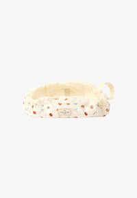 Cesto in tessuto color crema con stampe di pasticceria e tazze, chiusura a coulisse e forma rettangolare, dotato di un'etichetta su un lato.