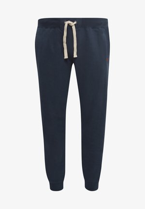 Navy Sweatpants aus Baumwolle, mit einem cremefarbenen Kordelzugbund, schmal zulaufenden Beinen und seitlichen Taschen für zusätzlichen Komfort.
