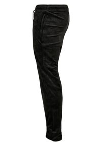 Sorte joggingbukser lavet af blødt stof, med elastisk taljebånd med snøre, smal benform og et subtilt teksturmønster.