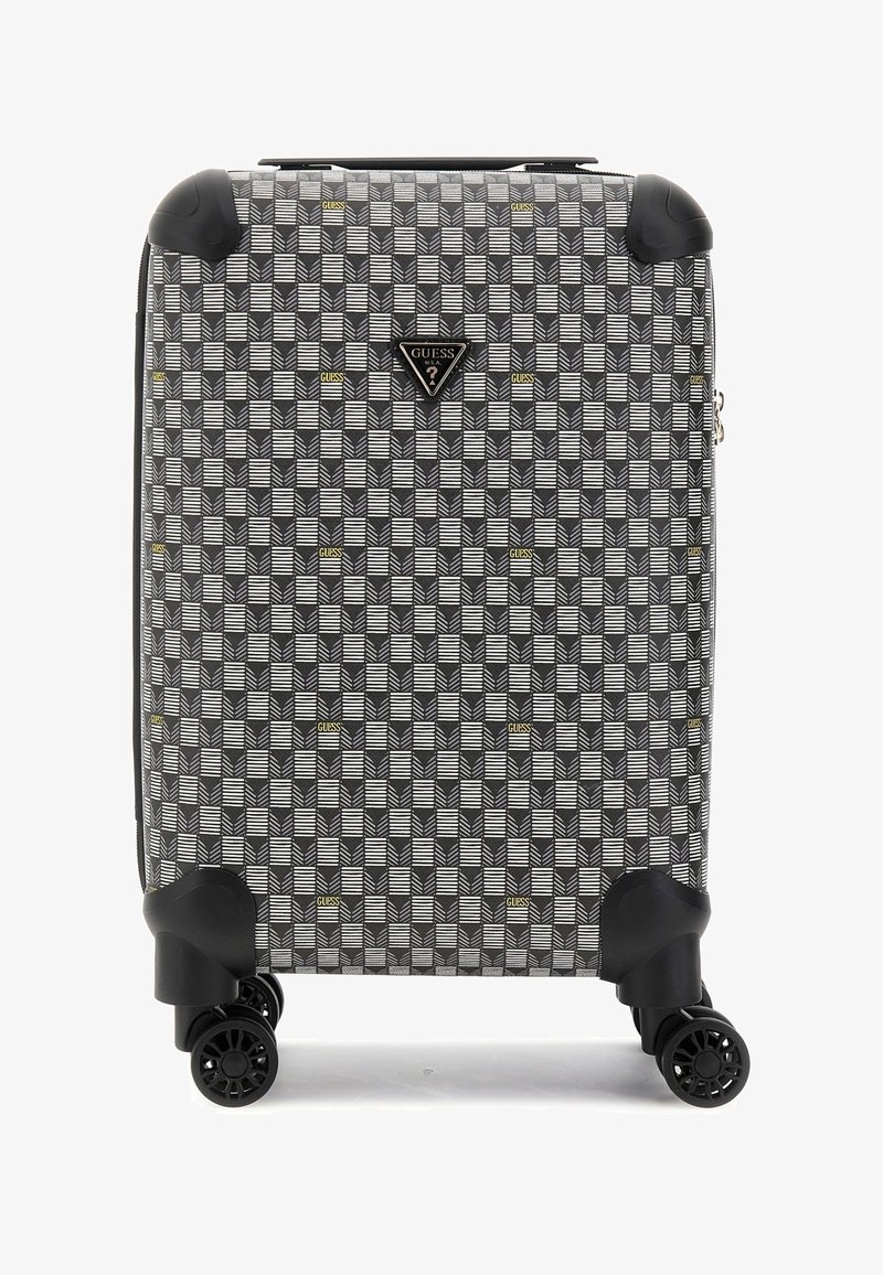 Valise à roulettes avec un motif géométrique noir et blanc agrémenté de touches dorées, coque rigide et quatre roues pivotantes à 360 degrés.