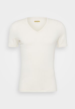 Kurzarm-Shirt mit V-Ausschnitt in Off-White, aus Merinowolle gefertigt. Glatte Textur, figurnaher Schnitt und minimalistisches Design mit sanftem Fall.