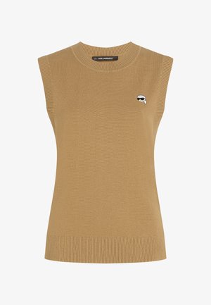 Ženski brezrokavnik iz kamelje rjave volnene preje z rebrastimi robovi in majhnim črno-belih vezenim obraznim logotipom na levem prsnem delu.