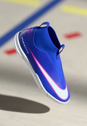 Modré sportovní boty na slip-on s bílým a růžovým logem Nike, bílou podešví a textem "AIR ZOOM" na světlejším podkladu s barevnými značkami.