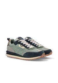 Zapatillas verdes y navy con materiales de ante y malla, que presentan una suela texturizada, diseño con cordones y un logo visible en el lateral.