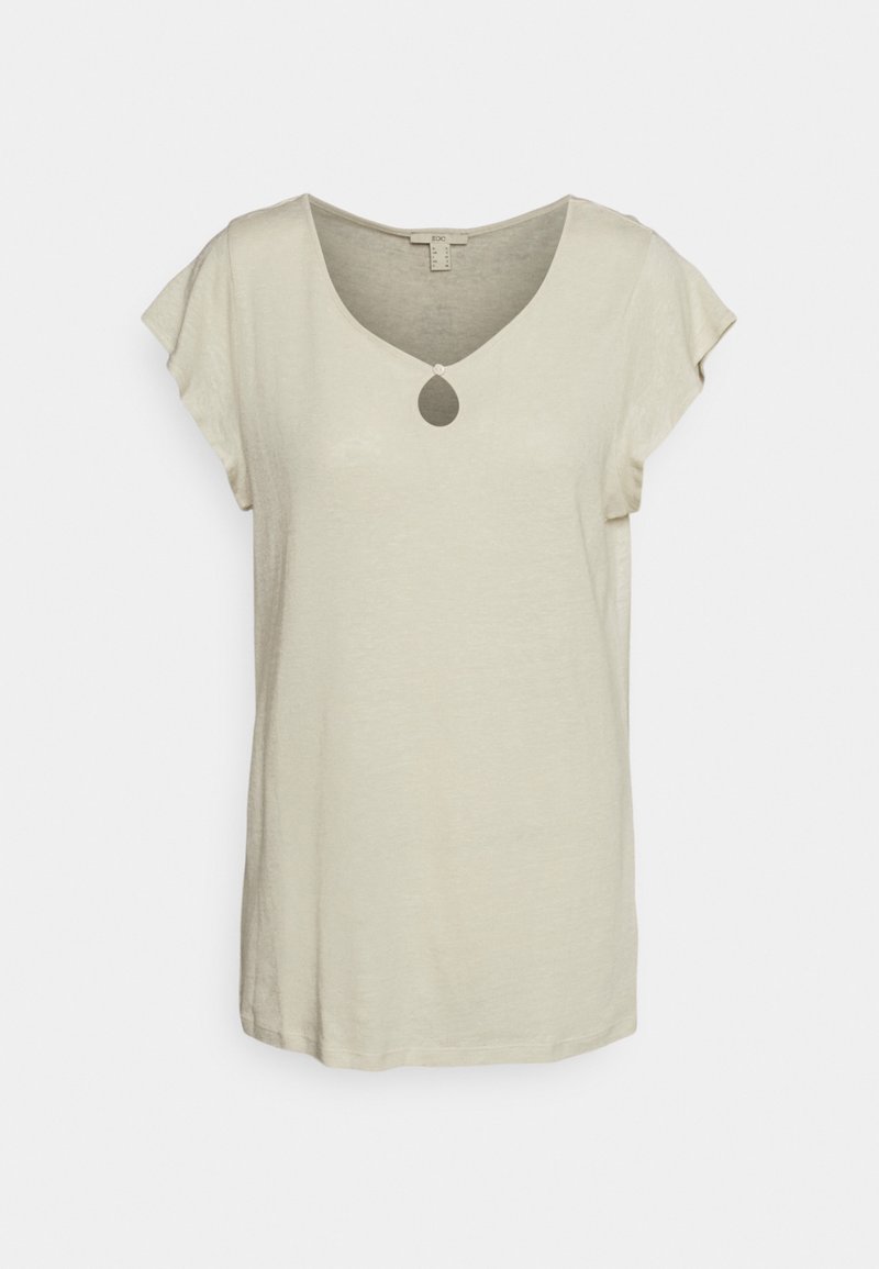 Haut beige pour femme à manches courtes, avec un décolleté en trou de serrure et une petite fermeture à bouton au centre devant.