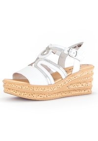 Witte wedge sandalen met leren banden en een cirkelvormig ontwerp. Beschikt over een textuur kurken zool met een gelaagd platformontwerp.