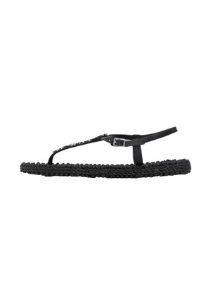 Black flat sandal with braided sole, thin T-strap embellished with small beads, and adjustable ankle buckle strap.