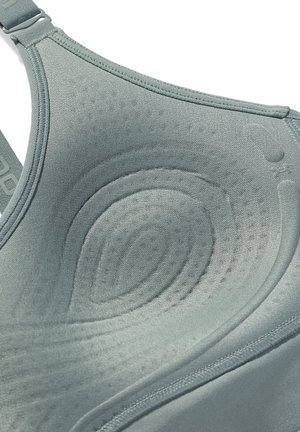 Rekbare, lichtgrijze sport-bh met naadloos textuur, gevormd ontwerp en gladde stof. Voorzien van verstelbare banden en subtiele ronde patronen.