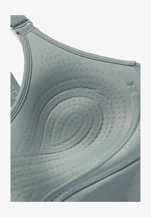 Rekbare, lichtgrijze sport-bh met naadloos textuur, gevormd ontwerp en gladde stof. Voorzien van verstelbare banden en subtiele ronde patronen.