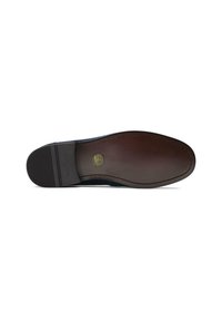 Dark blue textured leather shoe sole with a slightly raised brown edge. Features a circular logo and horizontal grooves for grip.