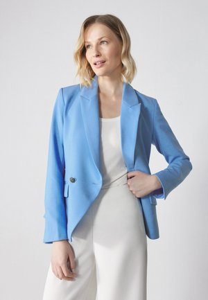 Light blue blazer with a tailored design, single button closure, notch lapels, and textured fabric; worn over a white top and cream pants.