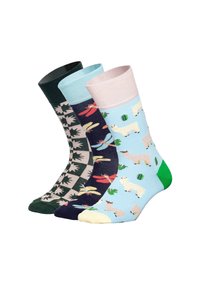 Tre par sockor: gröna med lövmönster, marinblå med trollsländor, ljusblå med alpackor, med kontrasterande ribbade mudd i pastellfärger.