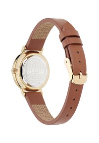 Montre avec bracelet en cuir marron, boîtier en acier doré, arrière embossé et doublure intérieure à motif ; résistant à l'eau jusqu'à 50m ; design minimaliste.