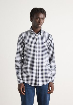 Navy and white gingham check shirt with button-down collar, long sleeves, and a chest pocket. Smooth cotton fabric, tailored fit.