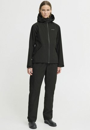 Black waterproof jacket with a zip closure and hood, paired with matching trousers. Material is smooth with a matte finish, minimalistic design.