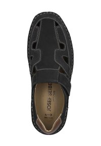 Sorte lædersandaler med netudskæringer og brune læderdetaljer. Har en Velcro-rem og kontrasterende beige syninger på sålen.