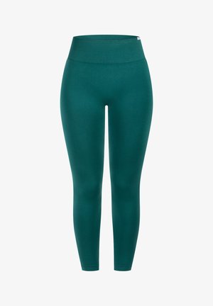 Leggings teal avec une large taille côtelée, une silhouette ajustée et une texture lisse. Pas de motifs proéminents ni de détails matériels.