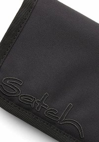 Black fabric wallet with a textured pattern, featuring a stitched logo in a matching shade. Edges are finished with a sturdy seam.