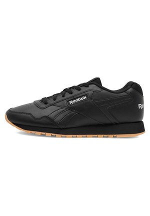 Schwarze Sportschuhe aus synthetischem Leder mit strukturierter Oberfläche, ausgestattet mit einer Gummisohle, Schnürdesign und Reebok-Logo.