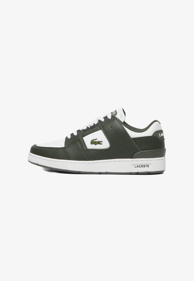 Baskets en cuir vert avec accents blancs, présentant un bout arrondi, un système de laçage, une surface texturée et un logo Lacoste. Semelle en caoutchouc.