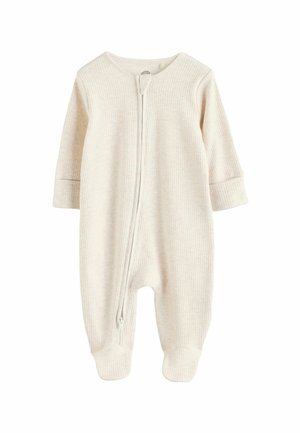 Tutina per neonato color crema realizzata in tessuto a costine, con chiusura frontale a zip, maniche lunghe e design con piedi.