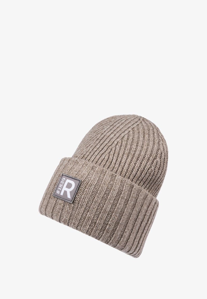 Beige ribbed knit beanie hat with folded cuff and a rectangular patch showing "#1839" and a large letter "R".