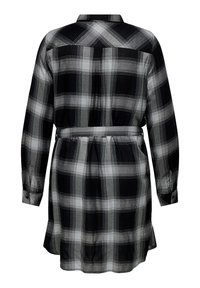 Black and white plaid shirt dress, long sleeves, belted waist, and buttoned cuffs. Textured fabric with a classic check pattern.