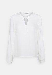 Blusa bianca a maniche lunghe con scollo rotondo e dettaglio a fiocco, caratterizzata da polsini arricciati e un tessuto liscio e leggero.
