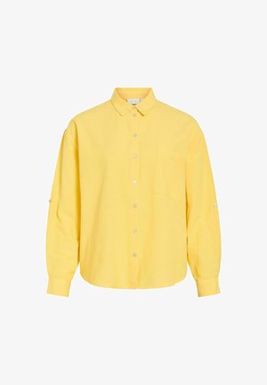 Chemise jaune à manches longues avec col, poche poitrine, et détails de boutons sur les manches et la patte de boutonnage avant.
