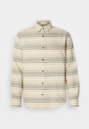 Pika puhvaga pikkade varrukatega särk, beež halva ja hallide triipudega. Omab rinna taskut ja pruune nööpe. Valmistatud tekstureeritud kangast.