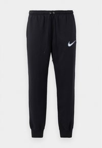 Zwarte Nike joggers met een elastische tailleband en een trekkoord. Heeft taps toelopende pijpen en een witte geborduurde logo op de linker dij.