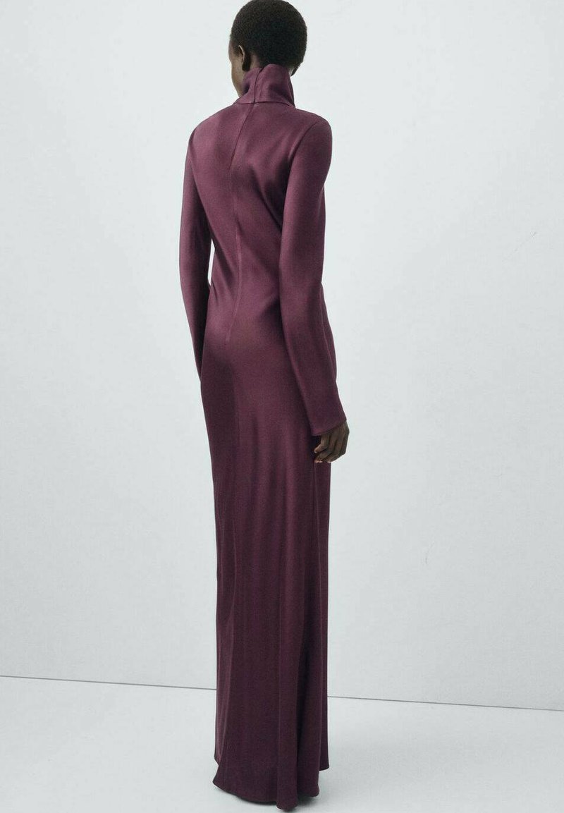 Long-sleeved, high-neck dress in deep burgundy, form-fitting with a smooth, stretchy texture, highlighting the silhouette and clean lines.