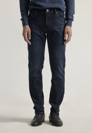 Vaqueros tapered - raw denim