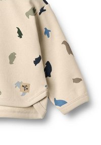 Beige sweatshirt med spredte dyresilhuetter i grøn, blå, sort og brun. Inkluderer et syet label med "WHEAT" branding.