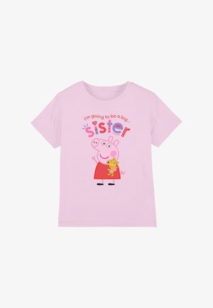 Pink cotton t-shirt featuring a cartoon character holding a toy, with the text "I'm going to be a big... sister" in colorful letters.