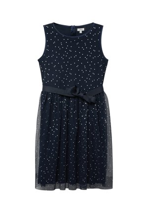 Ärmelloses, marineblaues Kleid mit weißen Punkten, einem transparenten Tüllrock-Überwurf und einem passenden Stoffgürtel, der in der Taille zu einer Schleife gebunden ist.