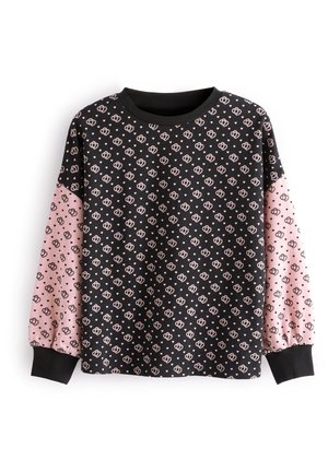 Chemise noire à manches longues avec des manches roses, présentant un motif répété de petits dessins en forme de cœur et des poignets noirs unis.