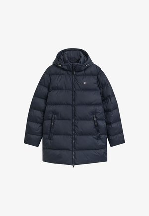 Casaco acolchoado azul marinho com capuz, fecho de correr e dois bolsos frontais. Apresenta um design matelassé e detalhes ajustáveis no capuz.