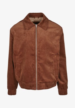 Giacca di corduroy marrone con colletto a bottoni, zip frontale, polsini a coste e tasche laterali. Foderata con un materiale morbido e testurizzato.