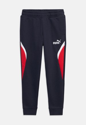 Pantalon de survêtement Puma bleu marine avec taille élastique, accents de panneaux latéraux rouges et blancs, et logo Puma sur la partie supérieure de la cuisse gauche.