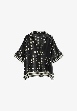 Schwarze Bluse mit kurzen Ärmeln, tiefem V-Ausschnitt, großen weißen und goldenen Punkten und einem kontrastierenden gestreiften Saum. Seidige Textur.