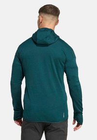Türkisfarbener Kapuzenpullover aus strukturiertem Stoff mit langen Ärmeln und geradem Saum. Mit Logodetail auf der unteren Rückseite.
