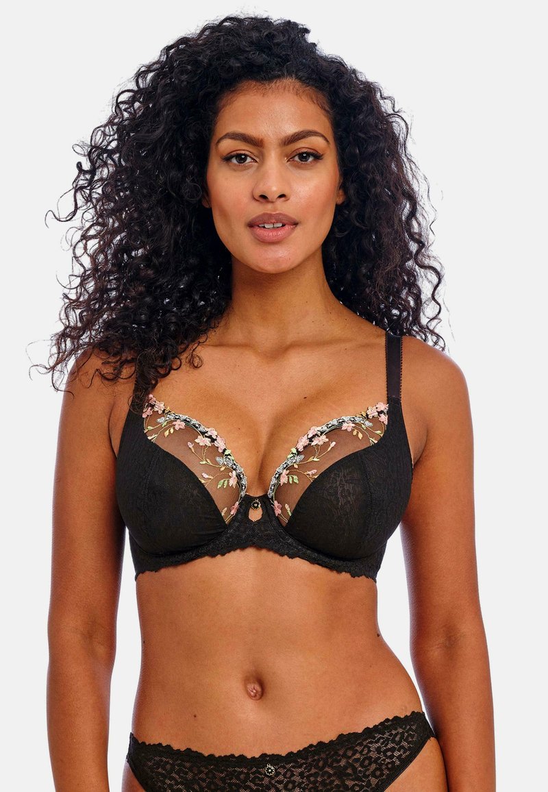 Black lace bra featuring embroidered floral details in soft pink and green on sheer cups, with a scalloped edge and small central embellishment.